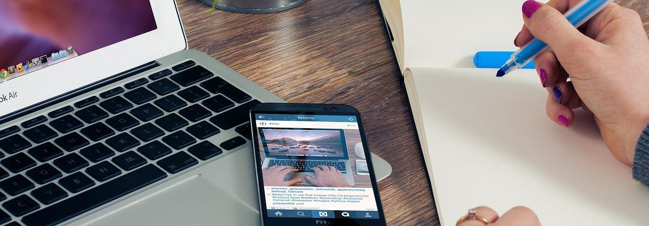 Writer with a laptop and a pen